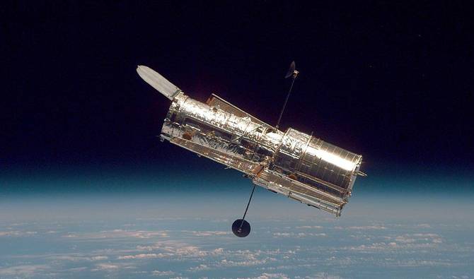 The Hubble Space Telescope drifts through space.