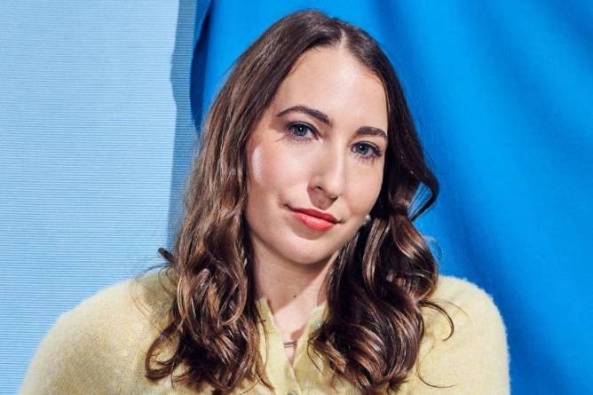 Rachel Karten photographed in front of a blue background