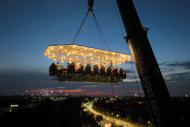 Eating dinner in the sky, held up by a crane