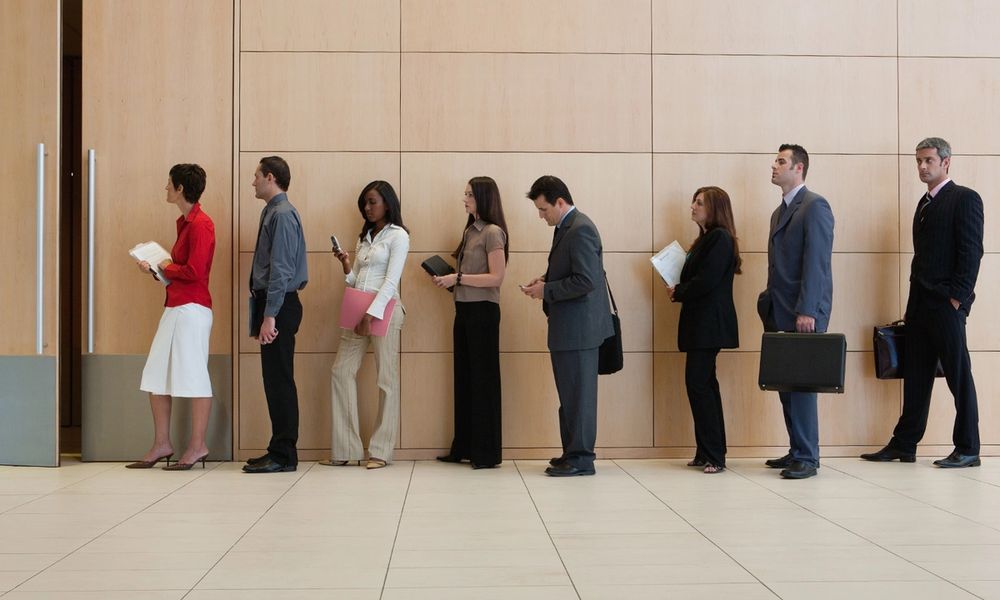 People waiting on line for interviews. (Credit: Tom Merton/Getty Images)