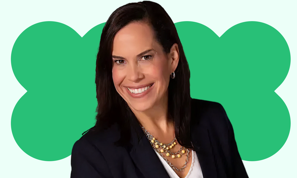 Photo of Allison Velez, a woman with long dark hair smiling broadly.