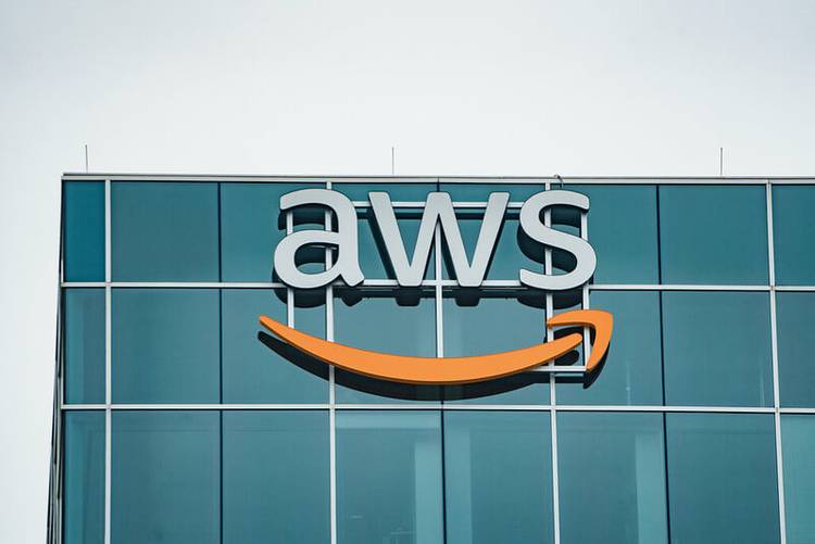 Logo of Amazon Web Services (AWS) on top of a glass building 