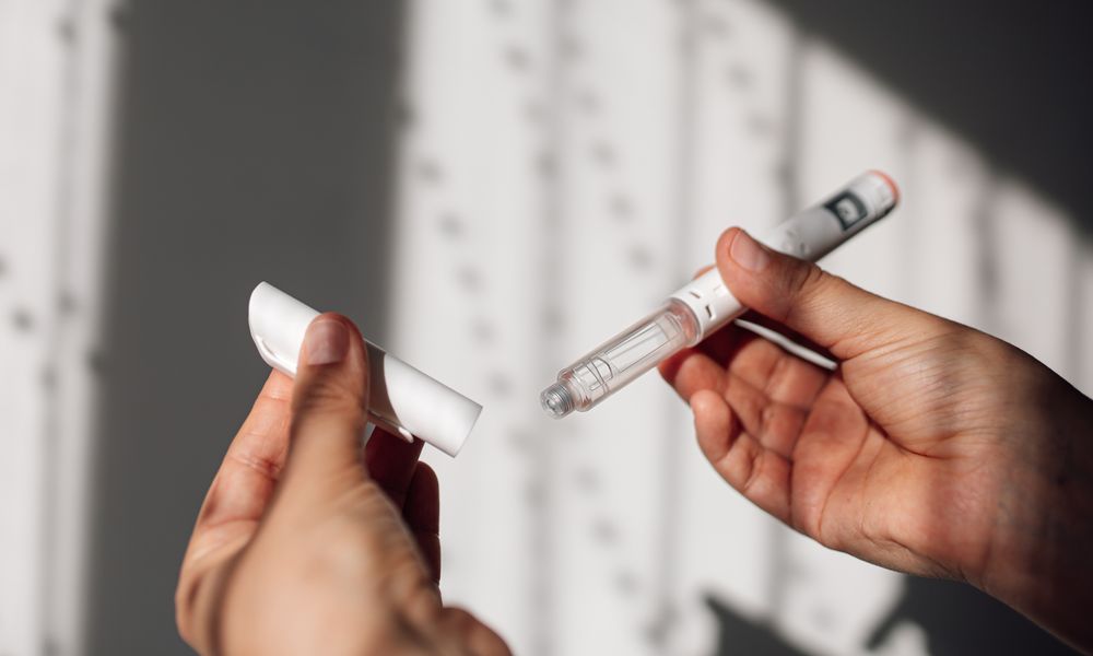 Semaglutide injection pen or cartridge pen for diabetics and weight loss in female hand. Medical equipment for diabetes patients