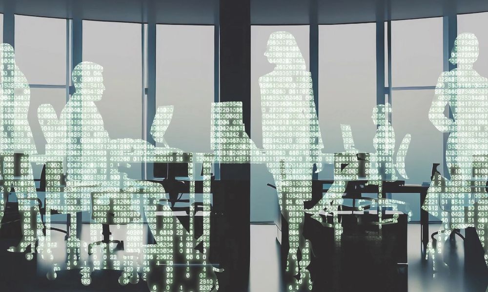 An office full of silhouettes of workers filled with The Matrix-style cascading computer code
