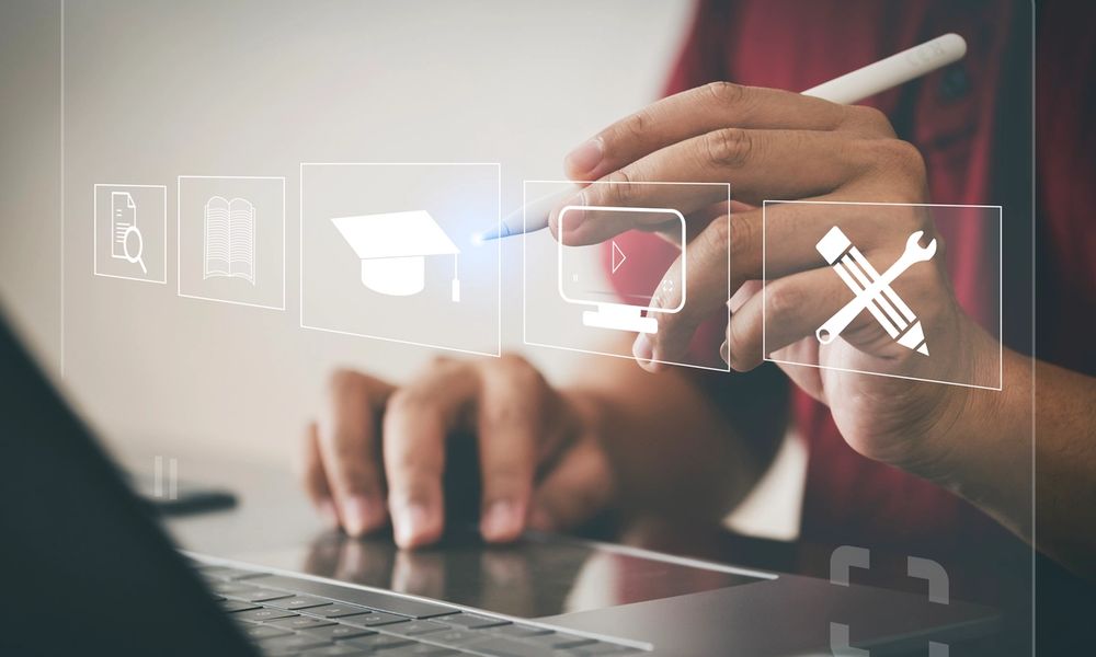 image of a hand pushing a learning button with a stylist pen in a digital space