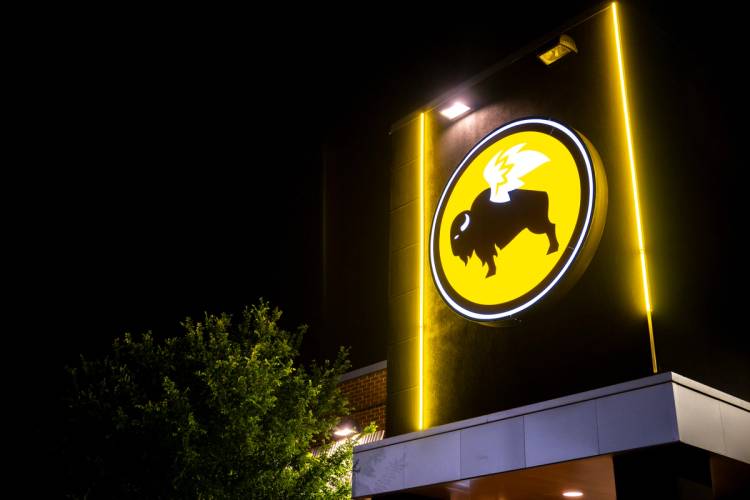 An illuminated Buffalo Wild Wings restaurant sign at night.