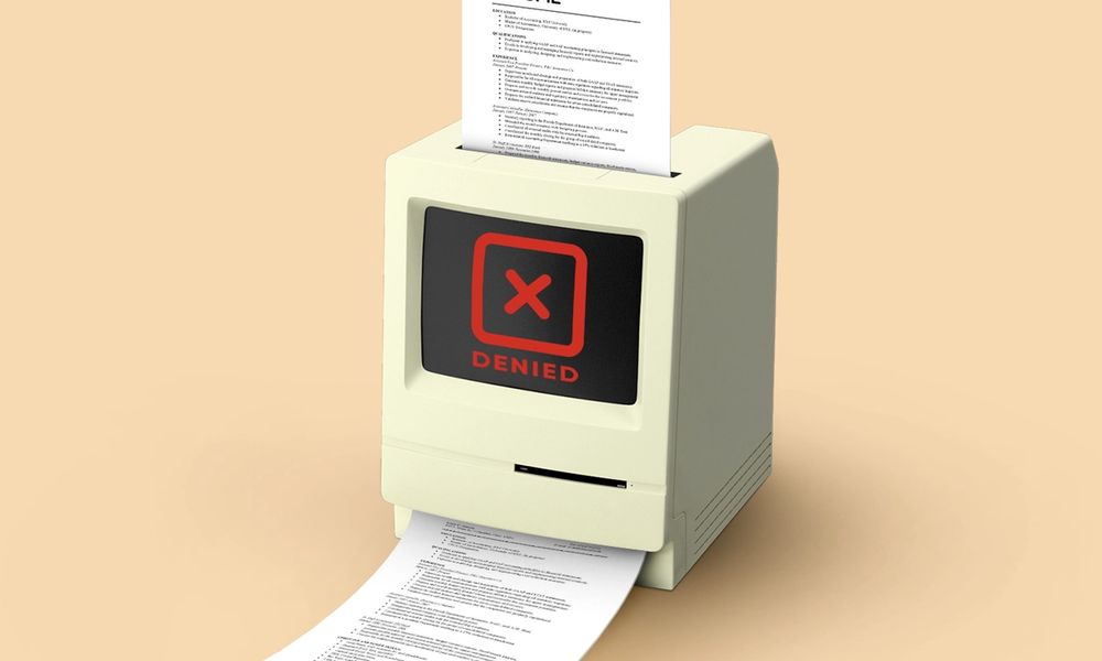 An illustration of a computer rejecting a resume.