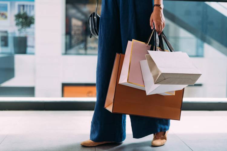 Hand holding luxury shopping bags