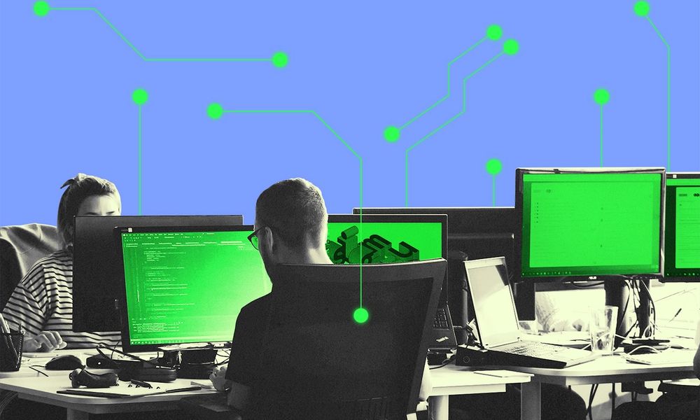 Workers in an office space with surrounded AI patterns.