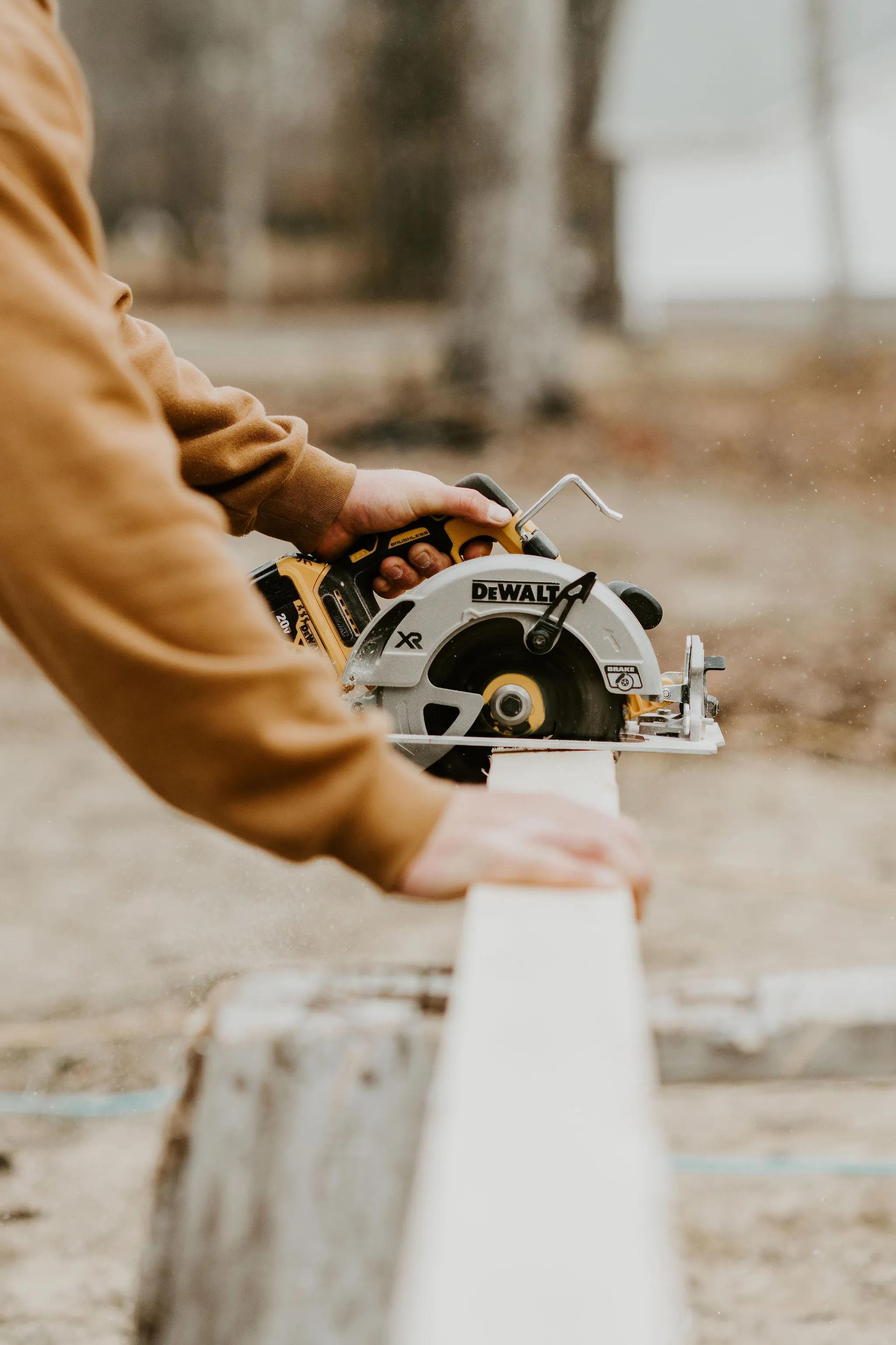 Man using a saw to cut wood