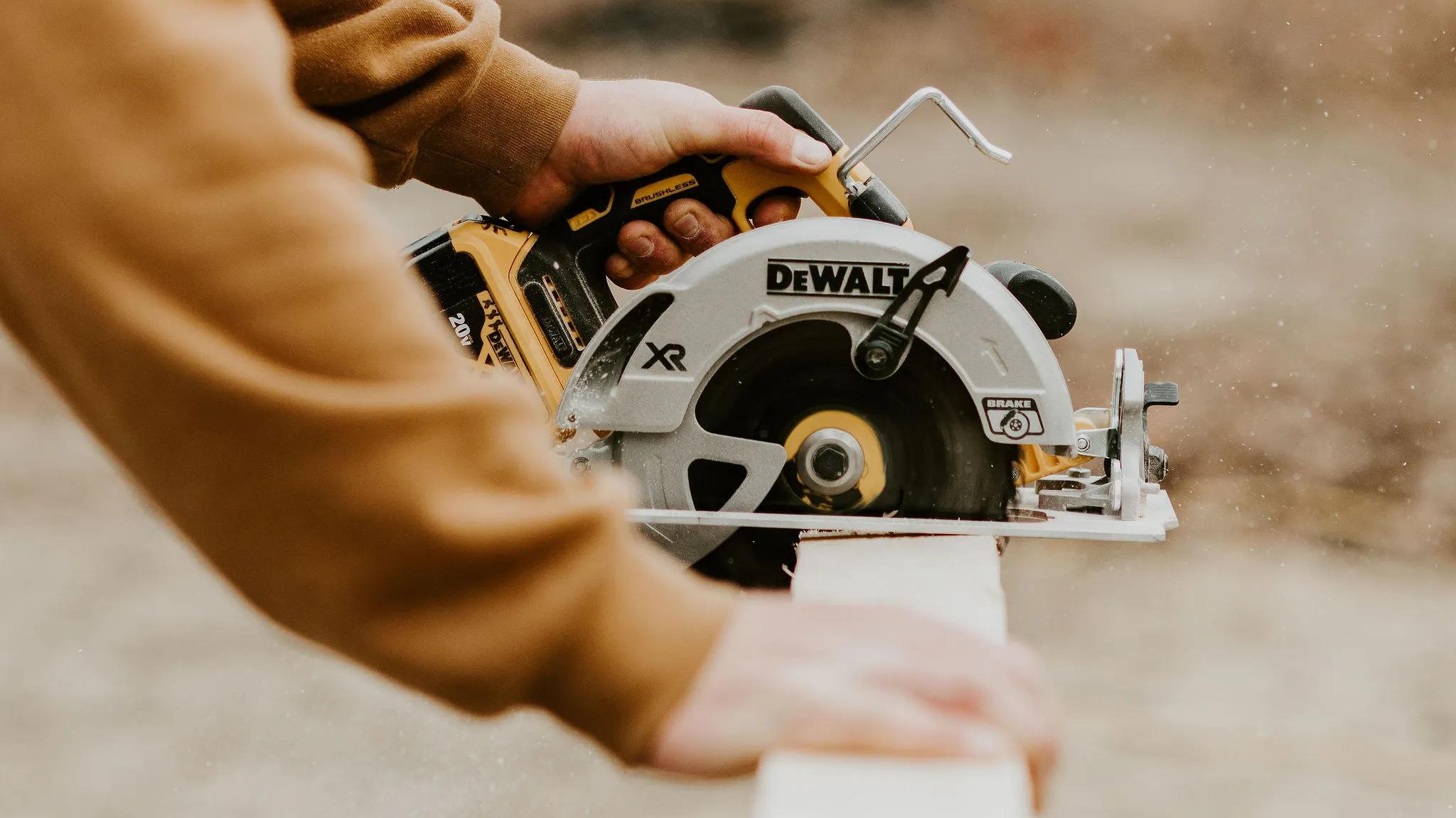 Man using a saw to cut wood