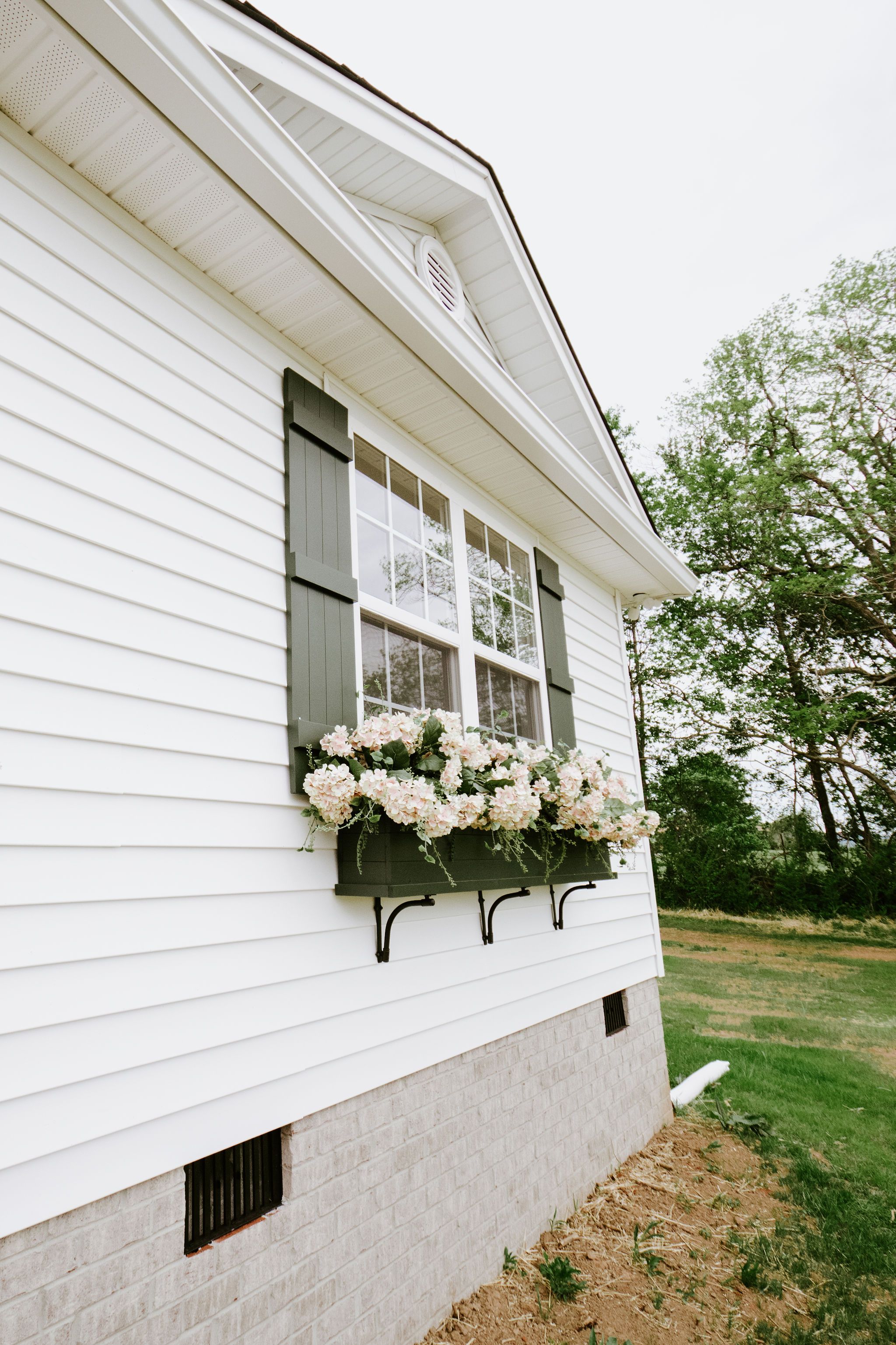 Side of home with flowers