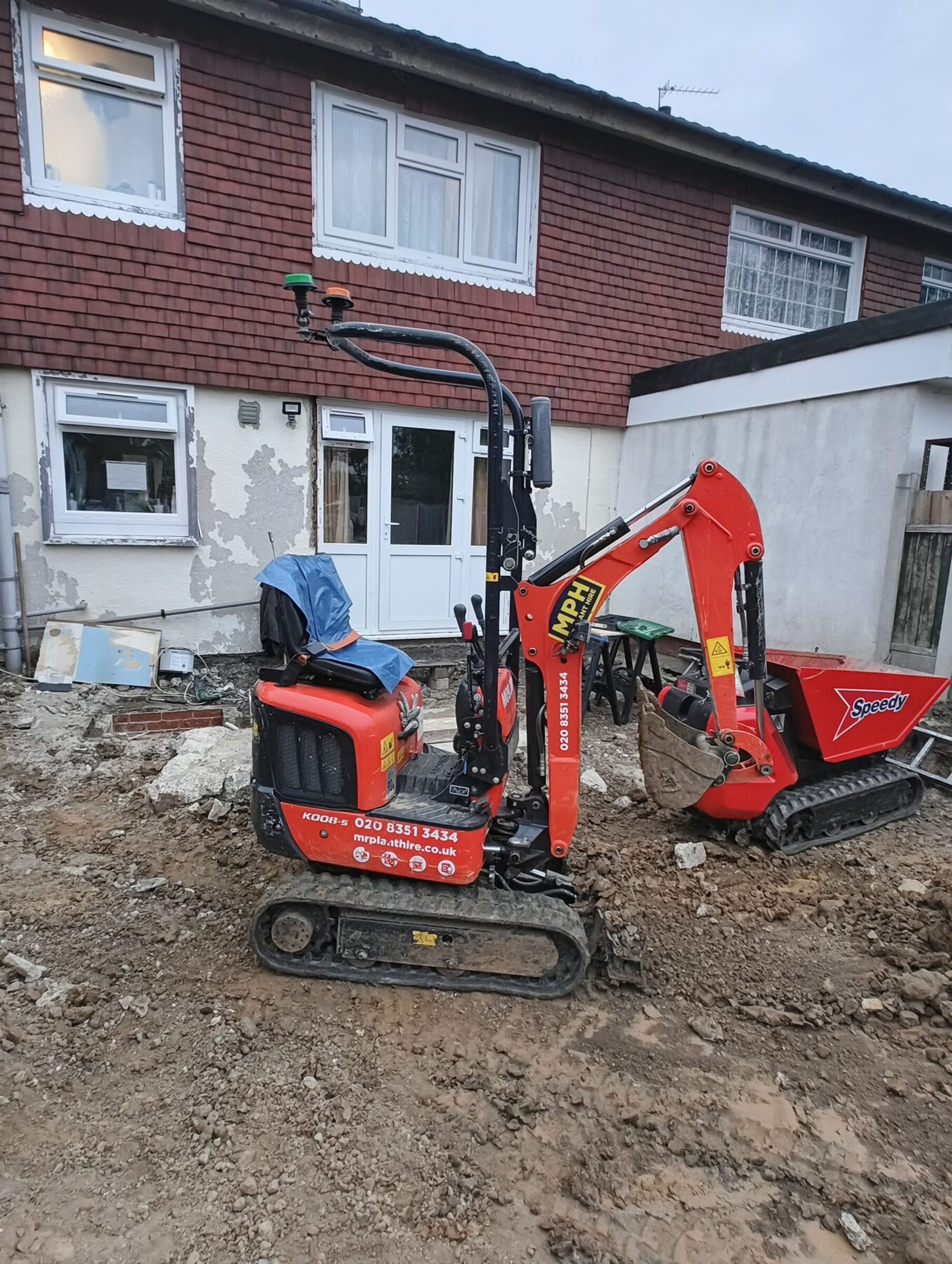 Mini digger and tracked dumper parked on a cleared rear garden for a Chigwell rear extension.