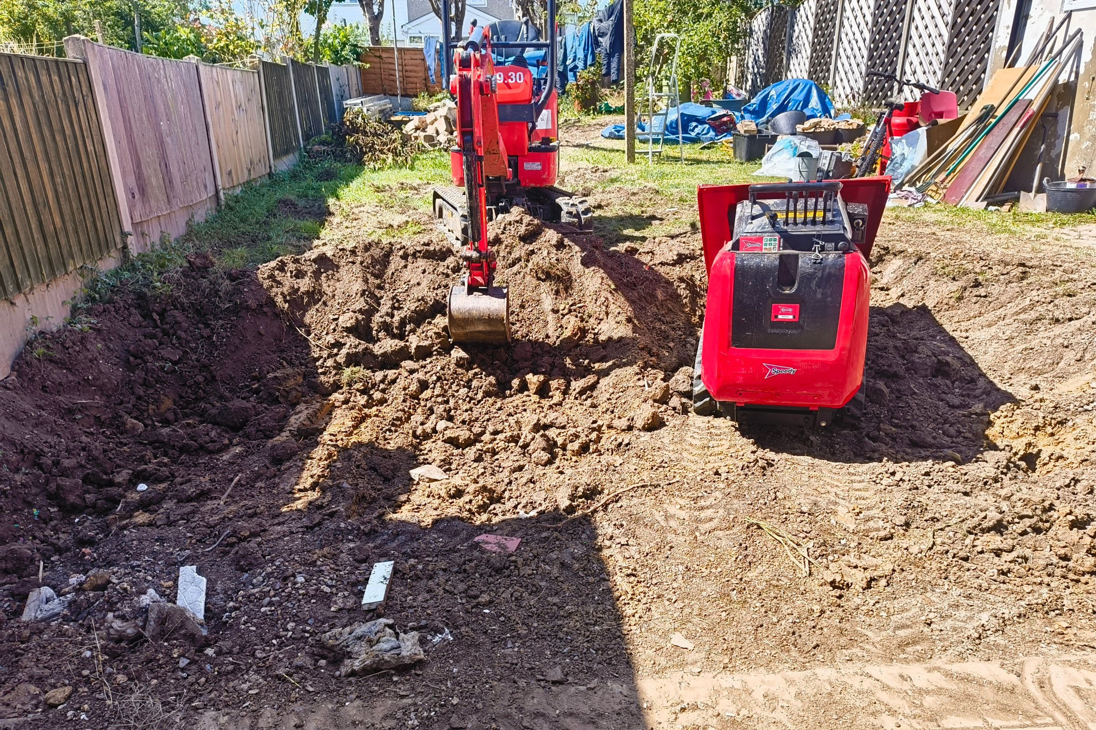 Digger digging out garden for rear extension