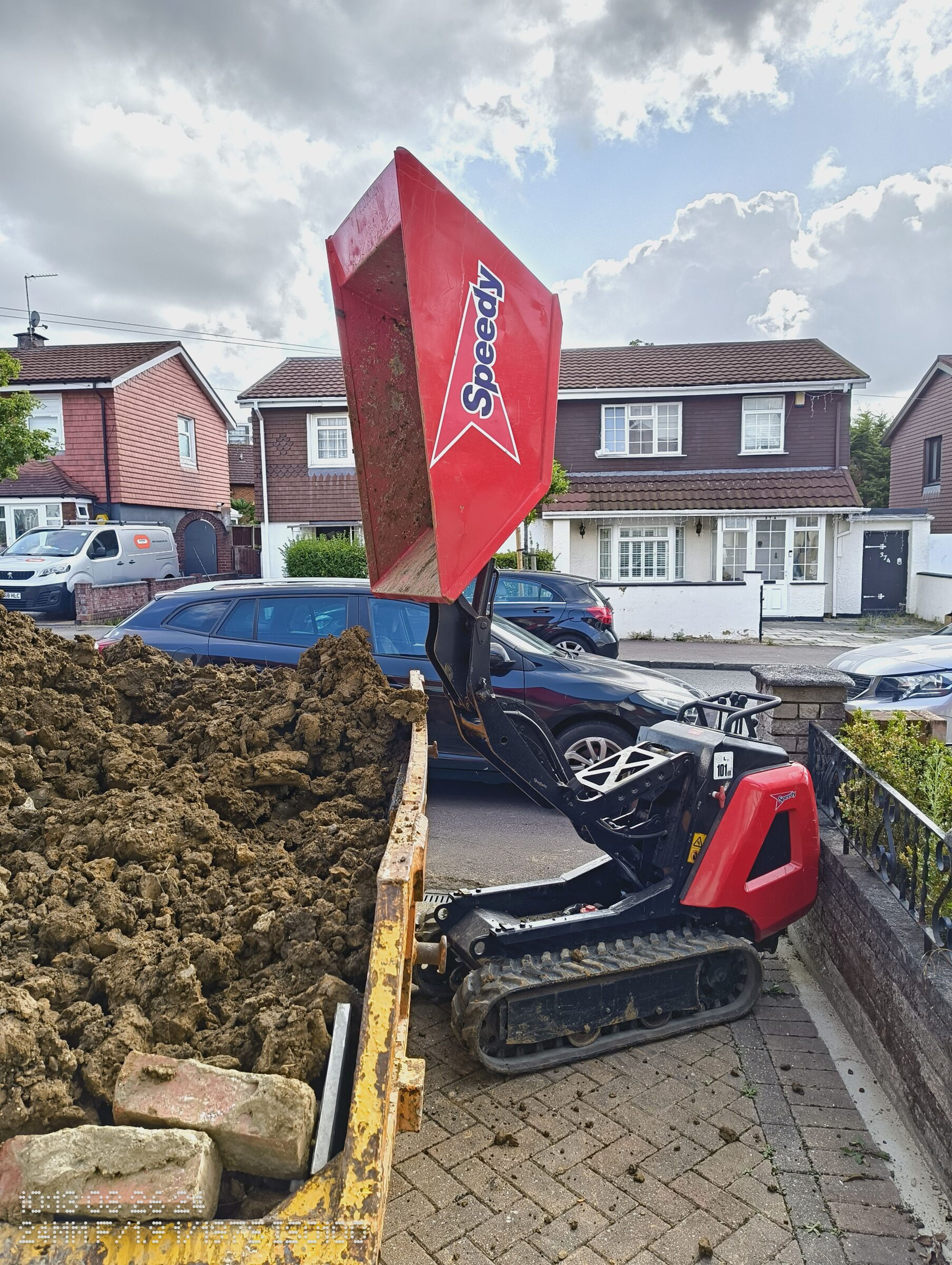 Empty tracked mini dumper after tipping soil into a skip for a Chigwell rear extension.