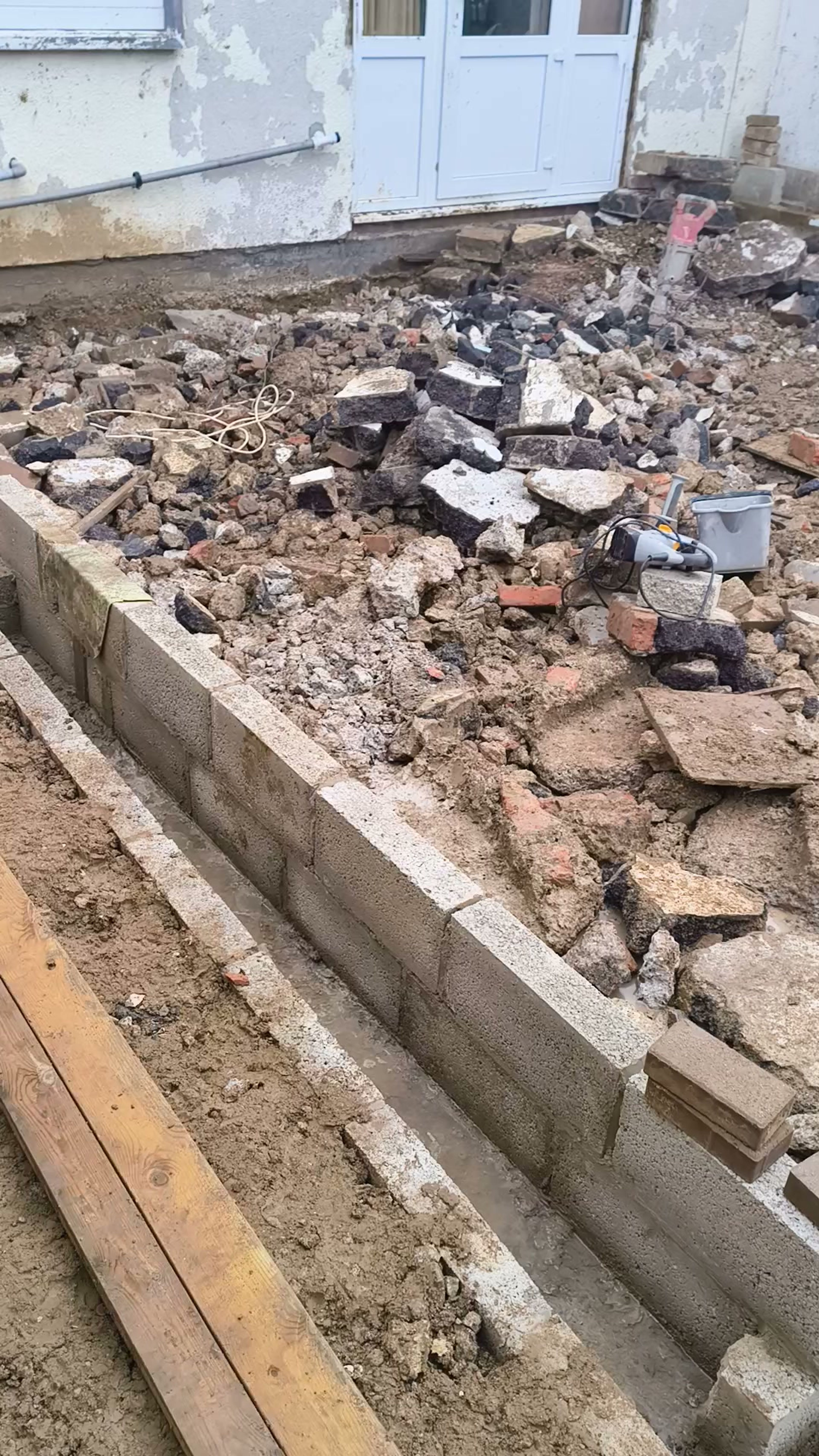 Block walls and a trench beside the rear extension footprint in Chigwell
