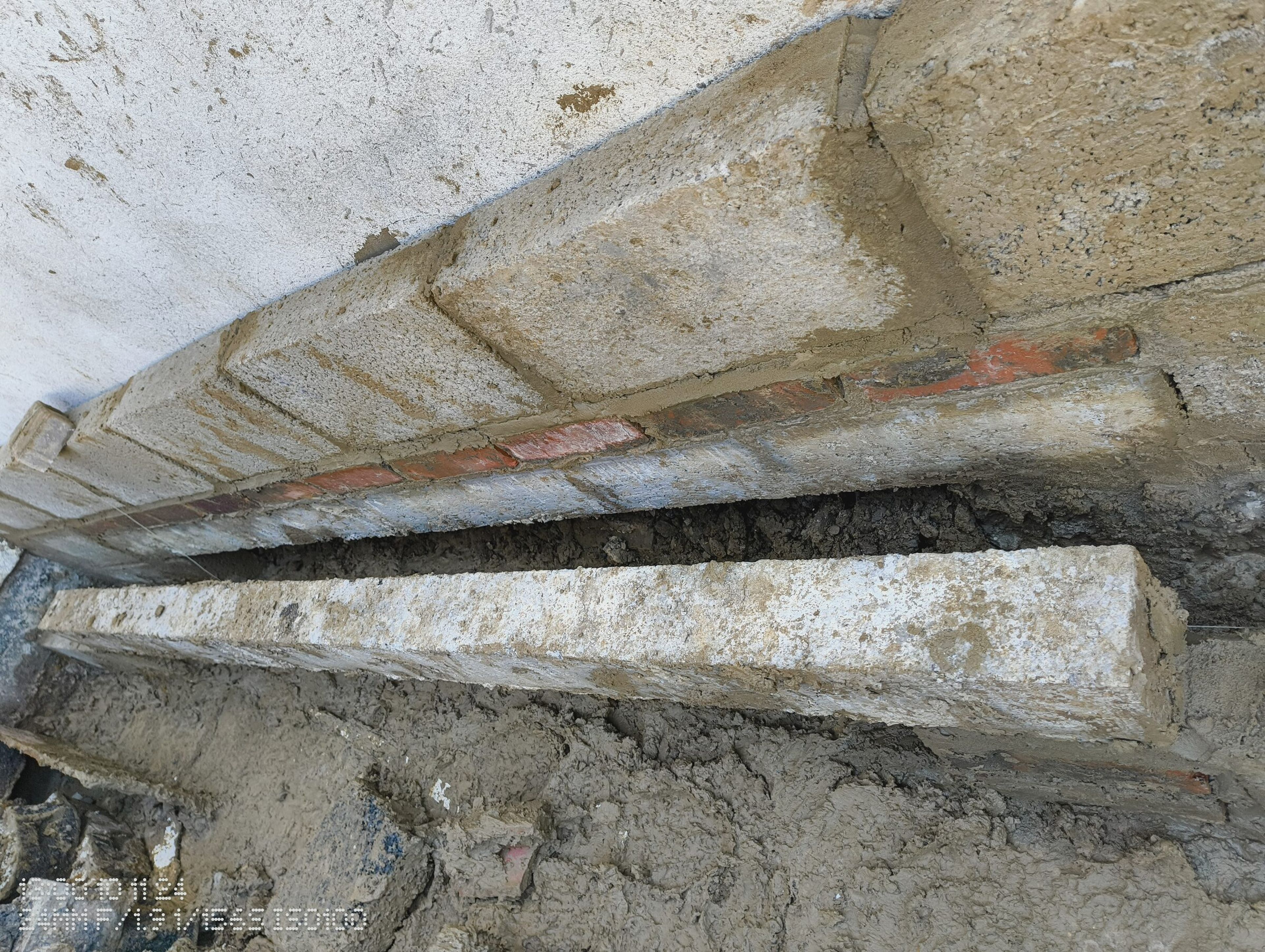 Close view of the new blockwork meeting the existing rendered wall.