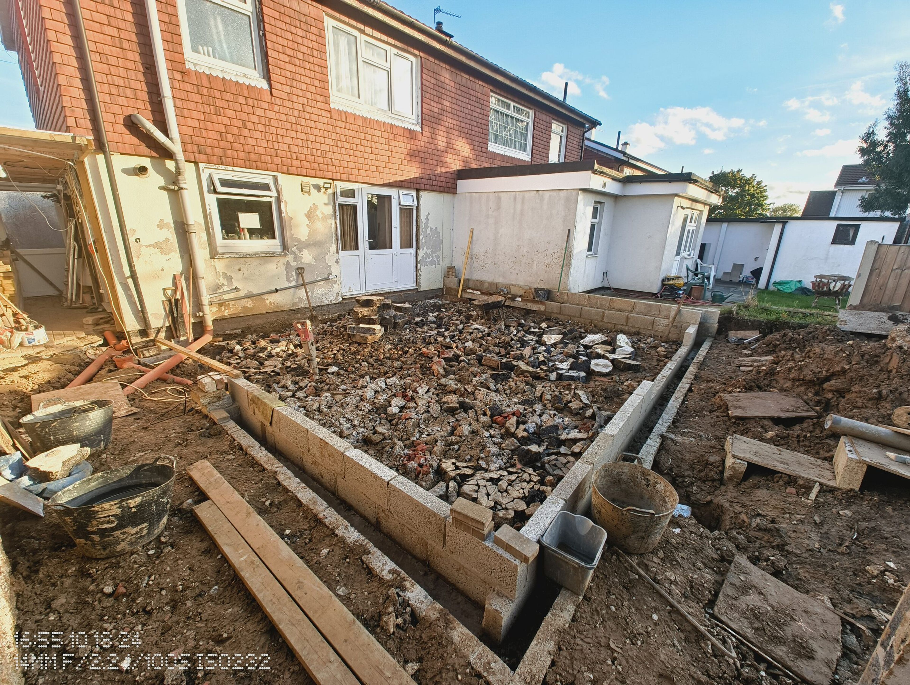 Blockwork walls around the Chigwell rear extension, filled with hardcore and ready for the concrete slab.