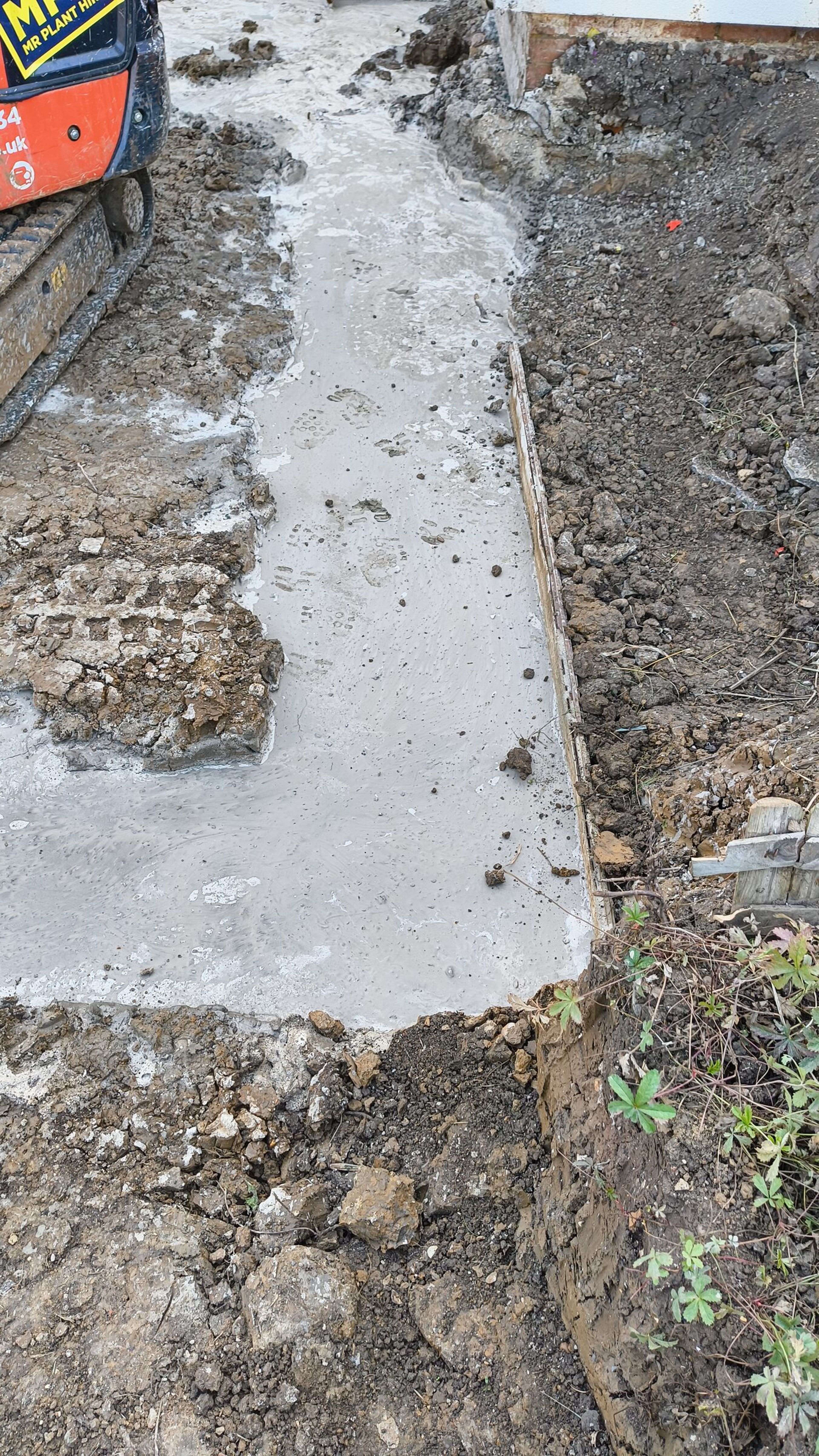 Fresh concrete poured into a foundation trench for a rear extension in Chigwell.