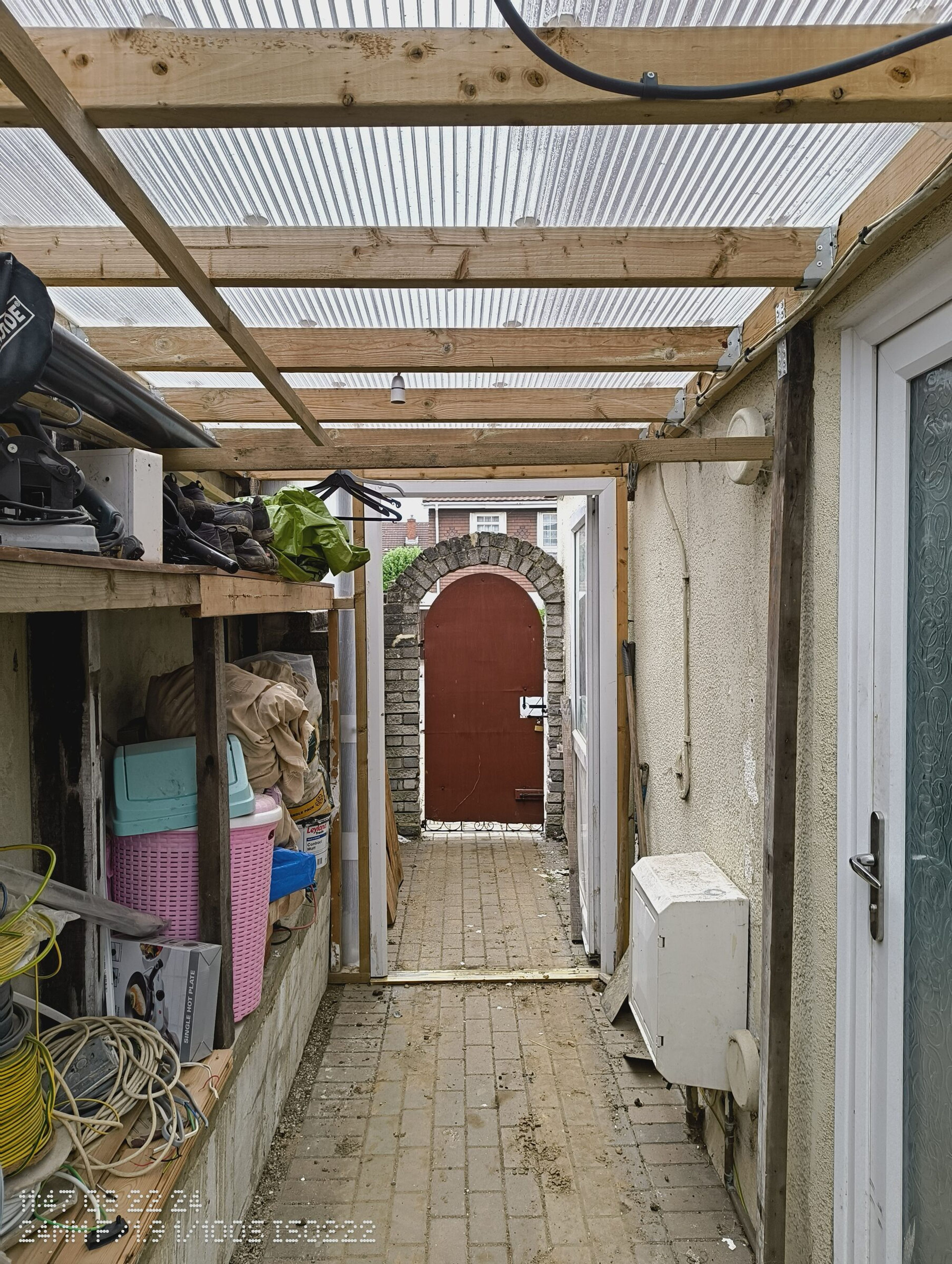 Side passage under the polycarbonate roof, looking through to the garden gate before the roof came off.