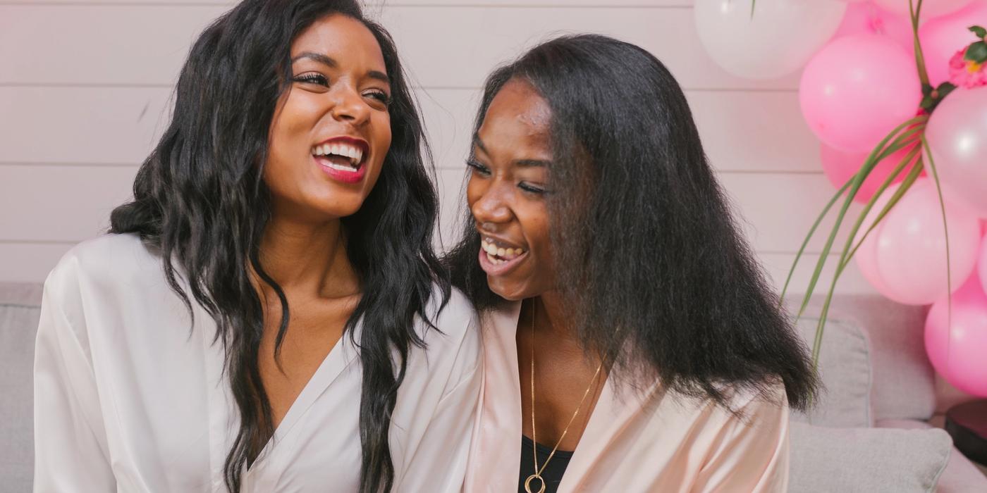 Two women celebrating a bachelorette weekend at a Respite and Revelry vacation rental in Charleston SC