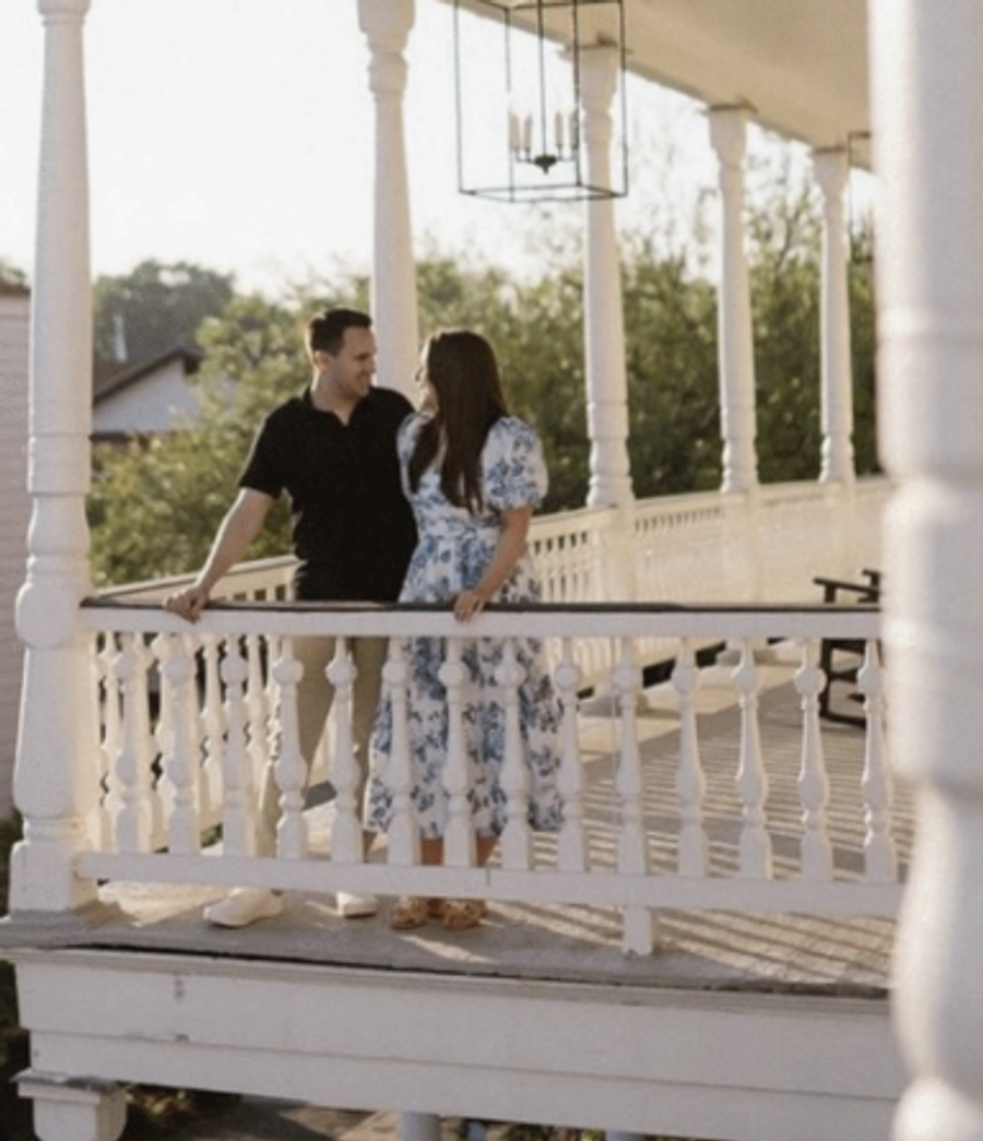 Couple on a historic Charleston piazza at a Respite and Revelry wedding weekend vacation rental