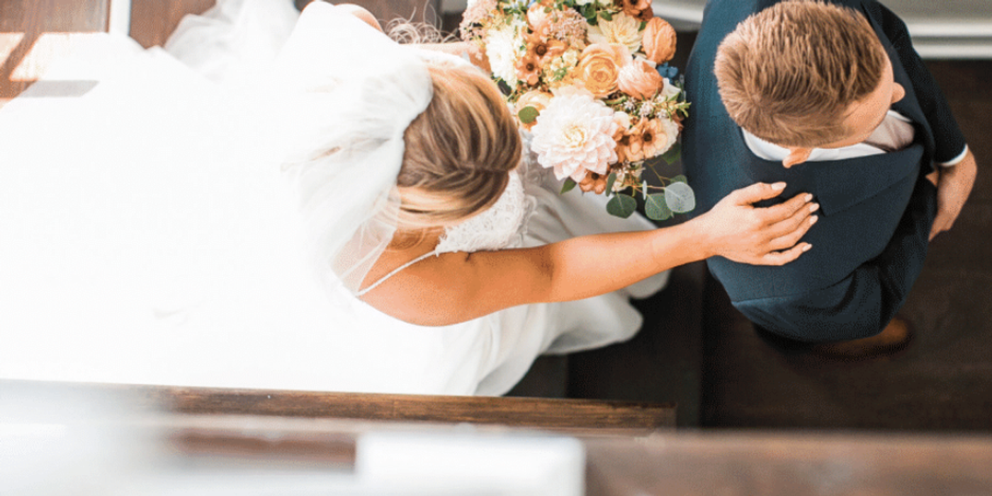Bride and groom embracing with bridal bouquet at a Charleston wedding weekend stay with Respite and Revelry Co
