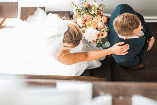 Bride and groom embracing with bridal bouquet at a Charleston wedding weekend stay with Respite and Revelry Co