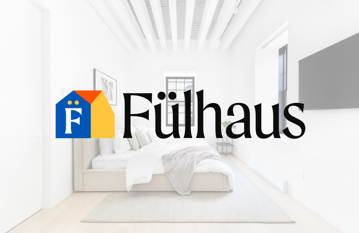 Fülhaus logo featuring a stunning interior design from the Fülhaus portfolio, showcasing a bright and inviting bedroom setting.