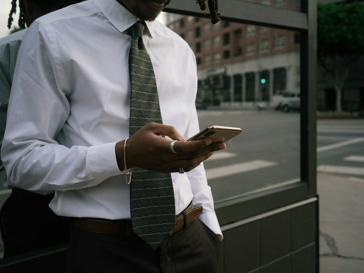 Business professional checking phone notification office