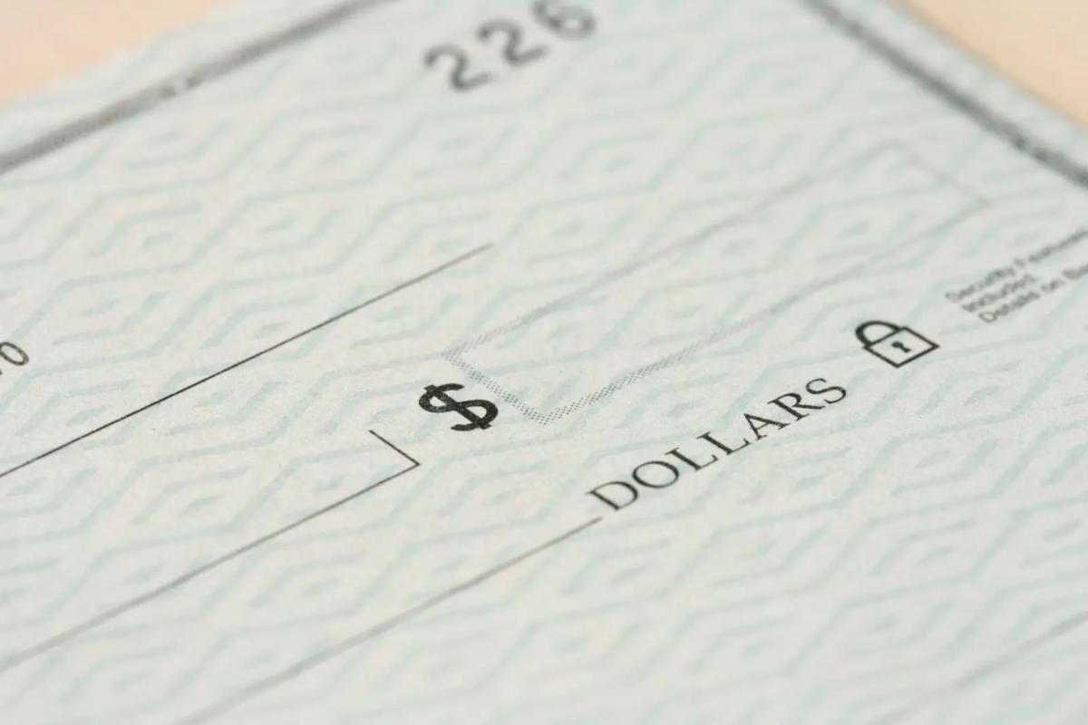 Paper check representing manual financial mail workflows and risks like delays, errors, and lack of visibility