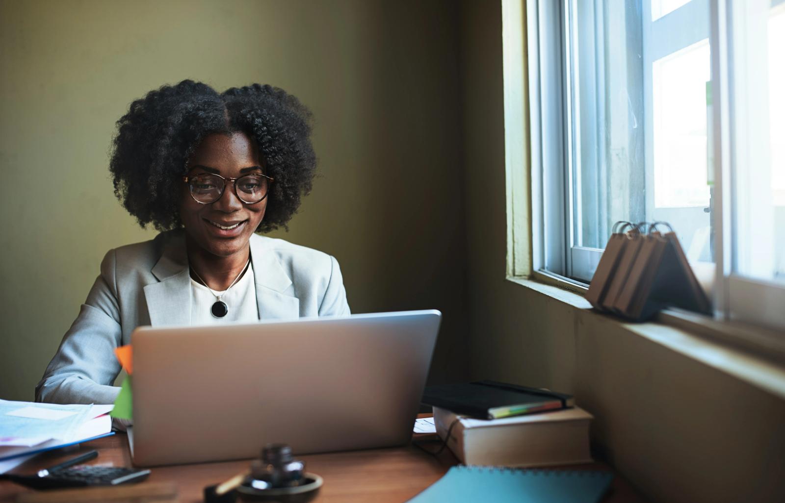 Business owner reviewing mail options on a laptop, deciding between a virtual address and virtual mailbox service.
