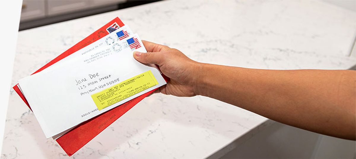 Example of a forwarded piece of mail with as yellow sticker