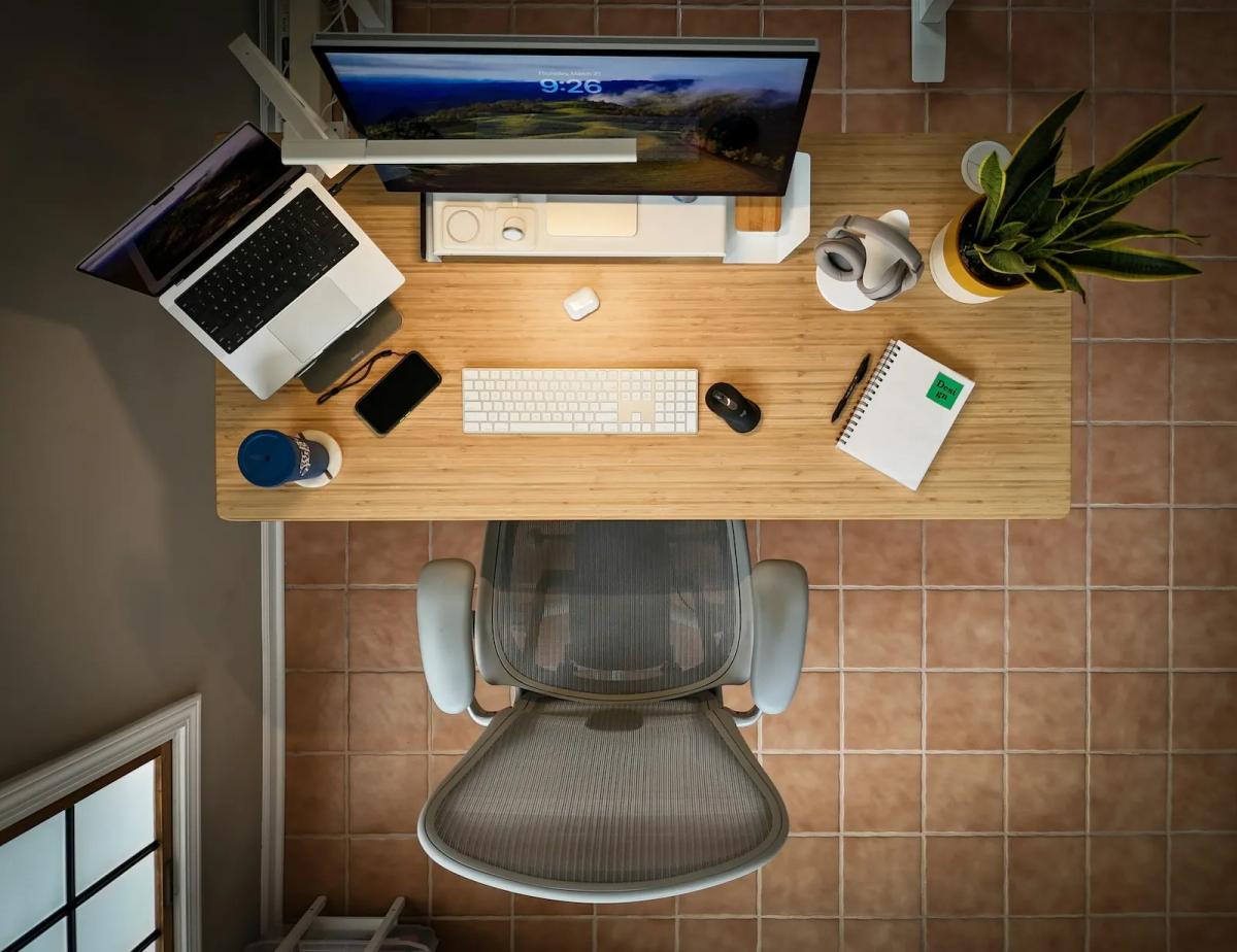 Top-down view of a clean, organized desk setup representing efficient office management