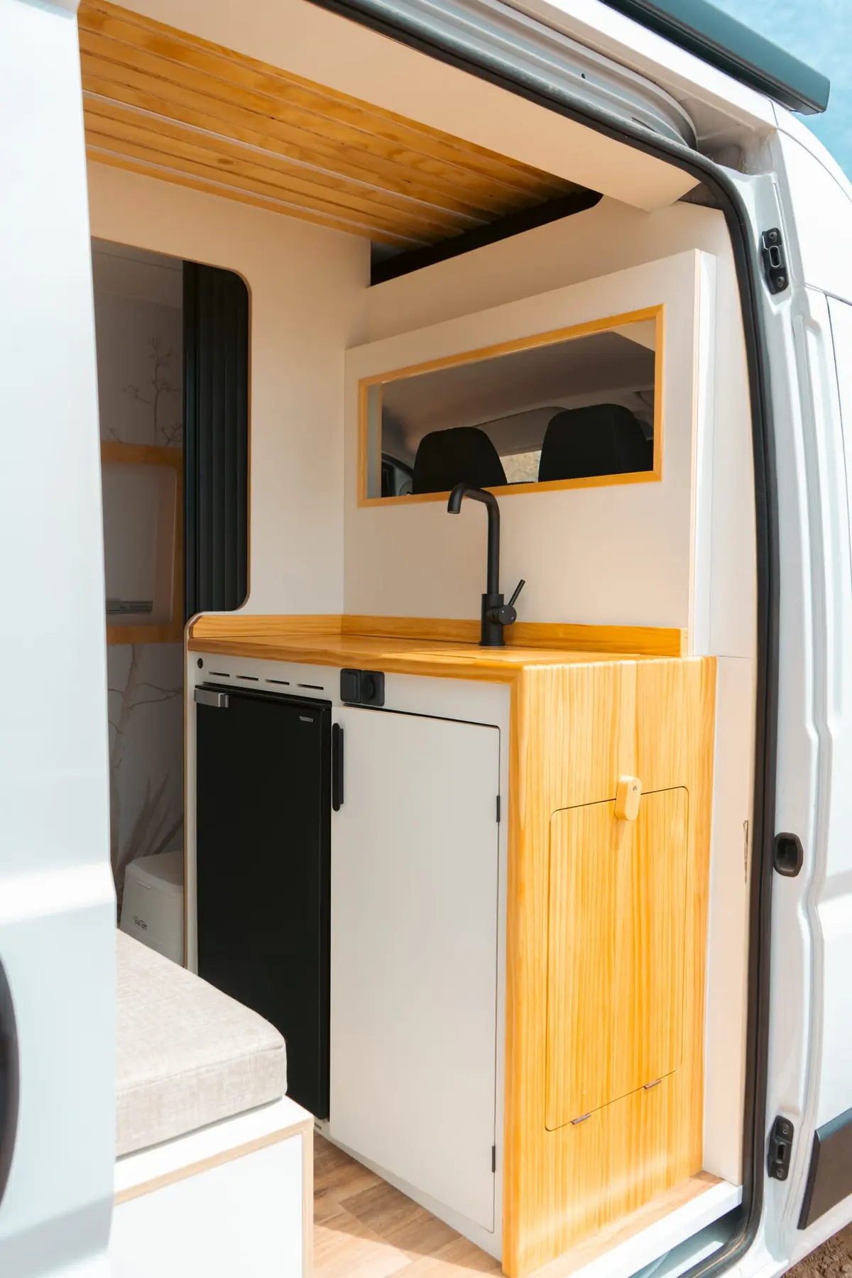 Cocina compacta de Van Brisa junto a la puerta lateral.