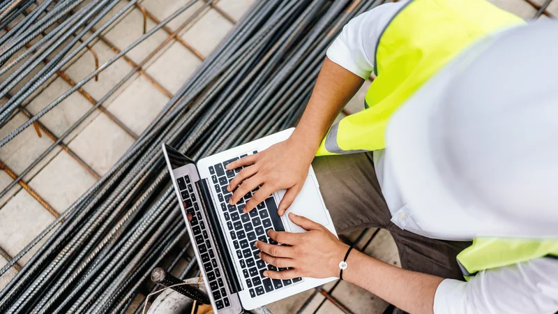 Construction safety team using EHS software to review jobsite records and follow-up