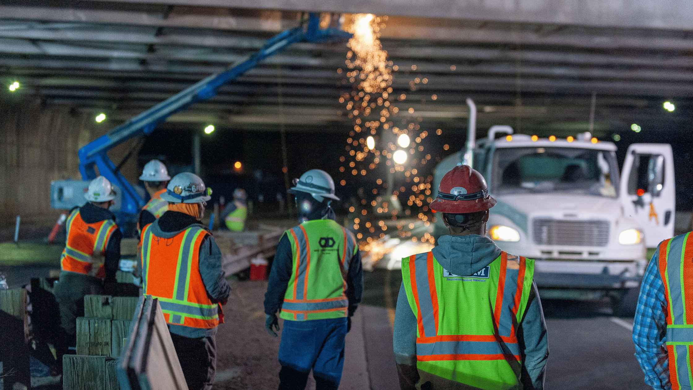 Construction leaders reviewing a risk management plan for an active jobsite