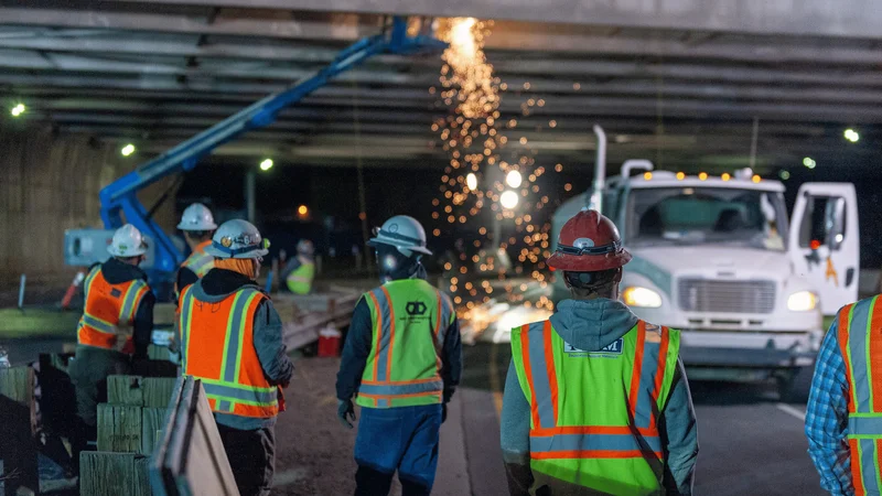 Construction leaders reviewing a risk management plan for an active jobsite