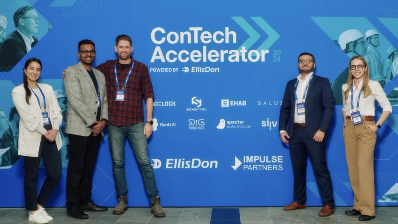 Participants standing in front of the 2024 EllisDon ConTech Accelerator event backdrop