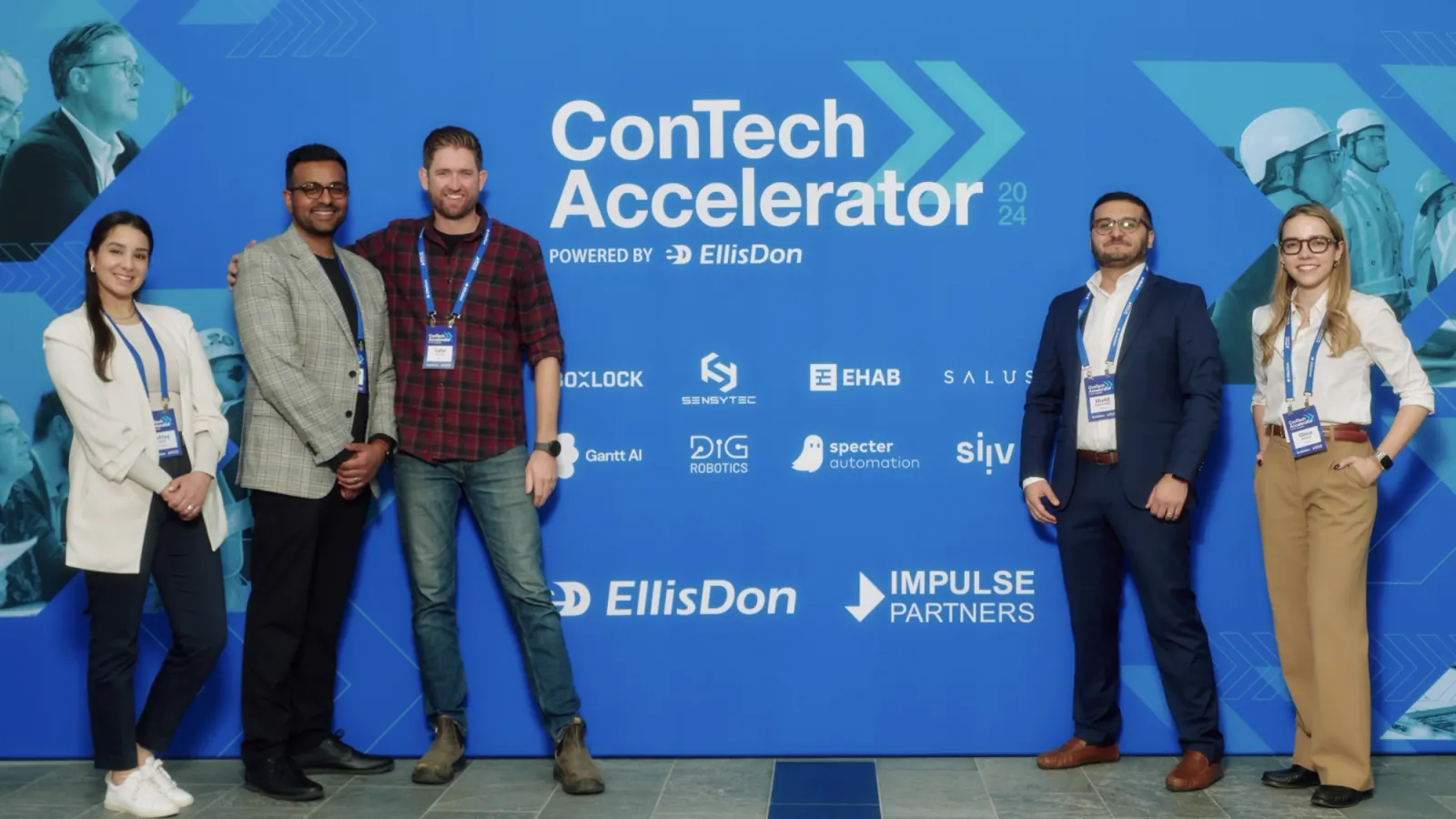 Participants standing in front of the 2024 EllisDon ConTech Accelerator event backdrop