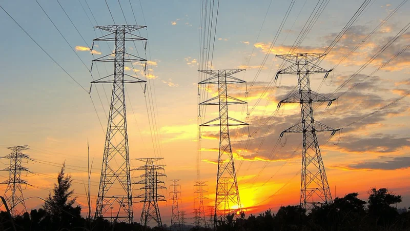 Electrical transmission towers and power lines at sunset