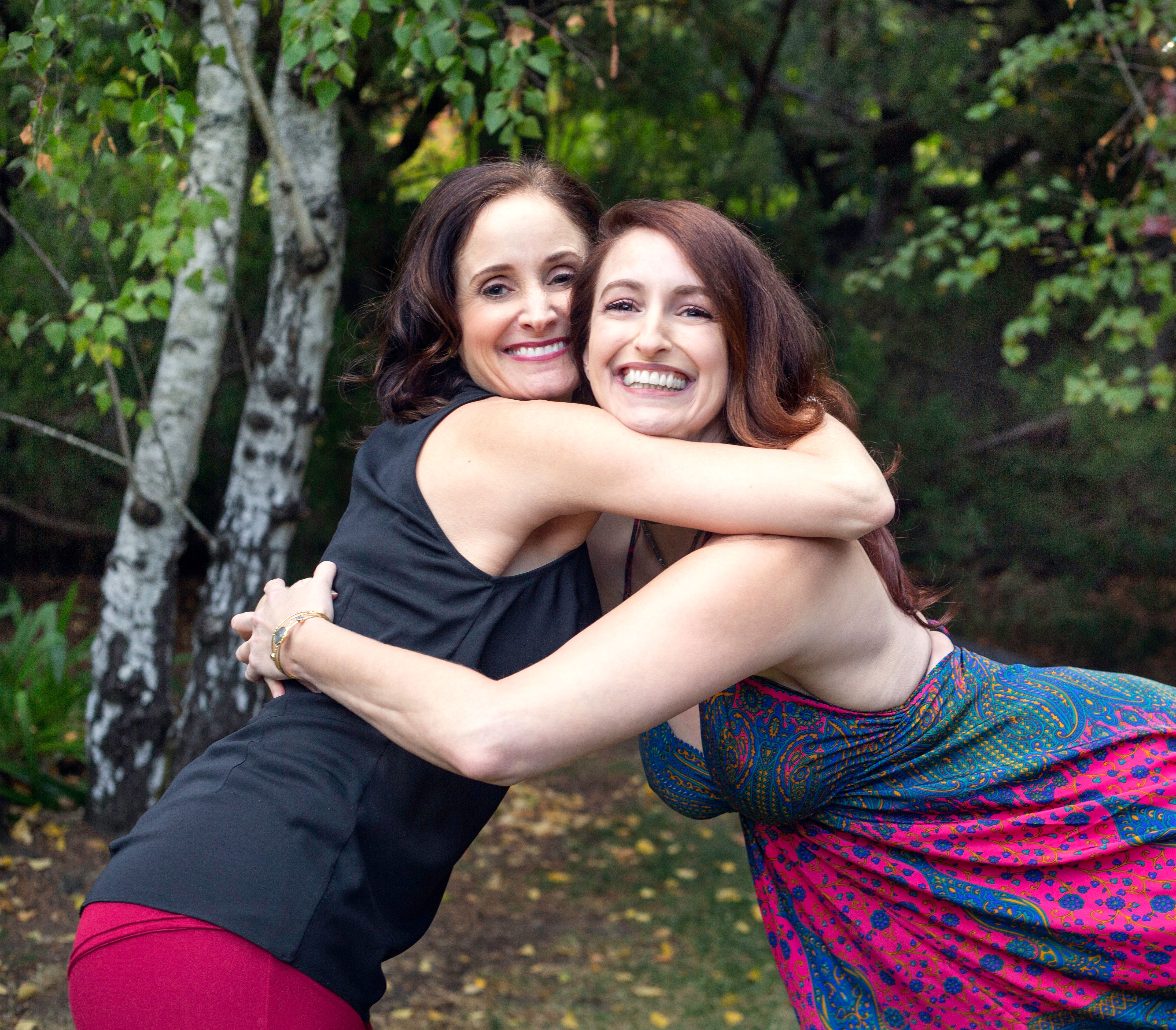 Two women laughing on the pole