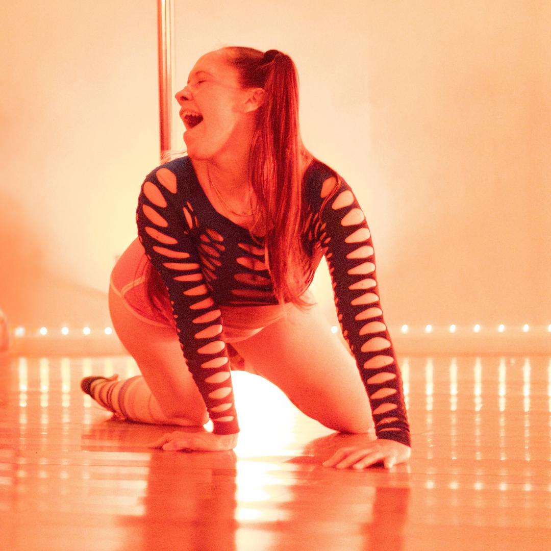 A student laughing on the studio floor