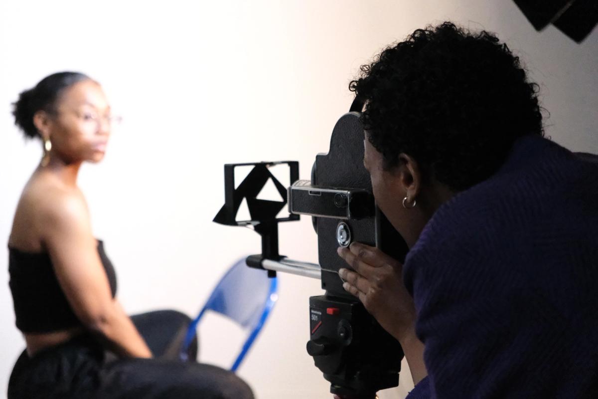 a woman is taking a picture of a woman with a camera .