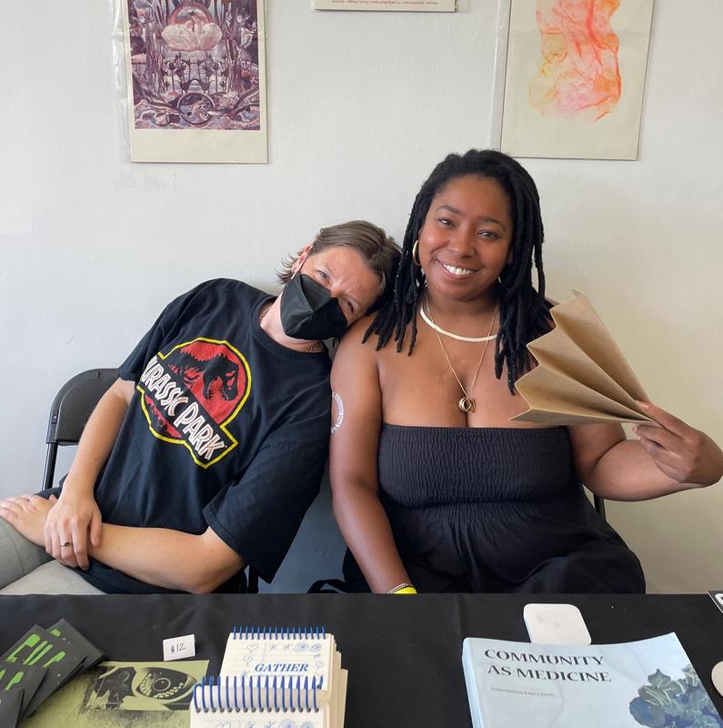 a man wearing a jurassic park shirt sits next to a woman