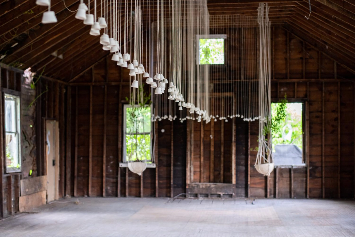 an empty room with a row of white lights hanging from the ceiling