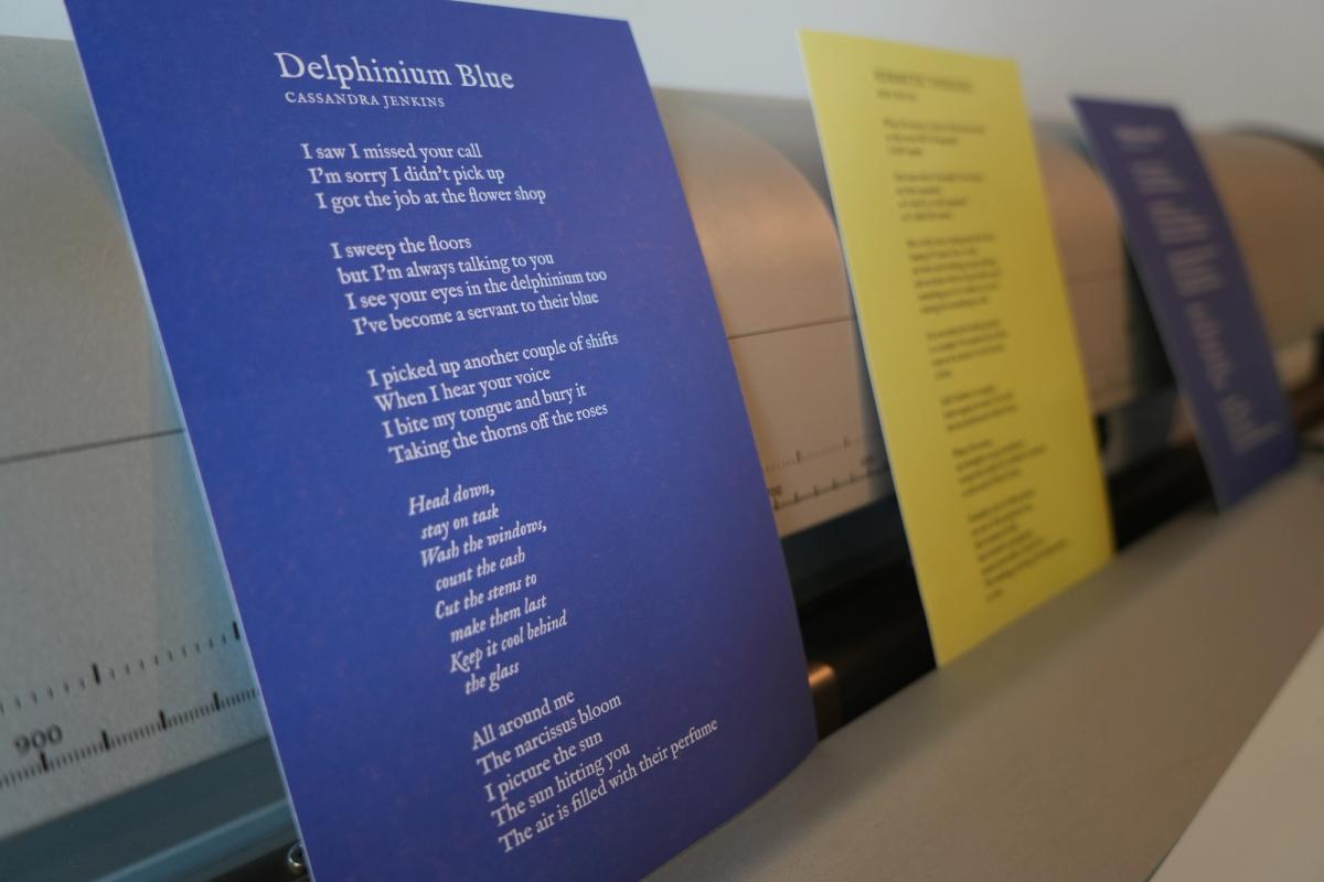 a row of papers with poems on them are sitting on a table .