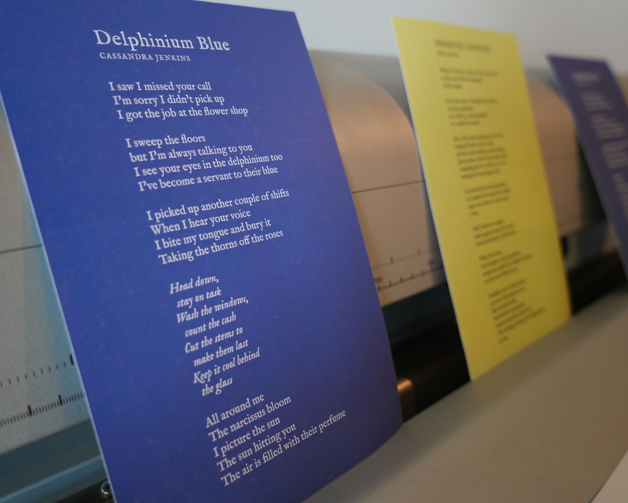a row of papers with poems on them are sitting on a table .