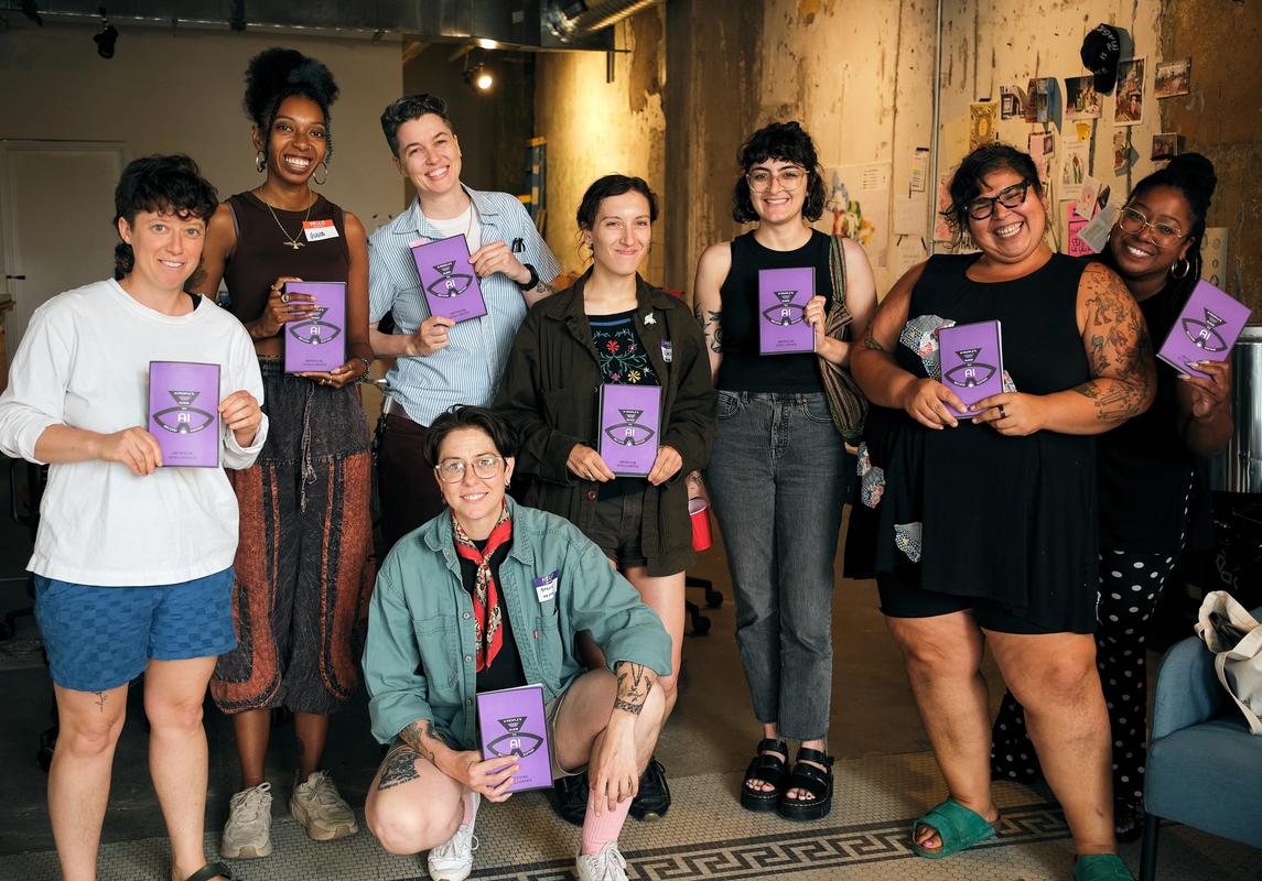 a group of women are posing for a picture while holding books .