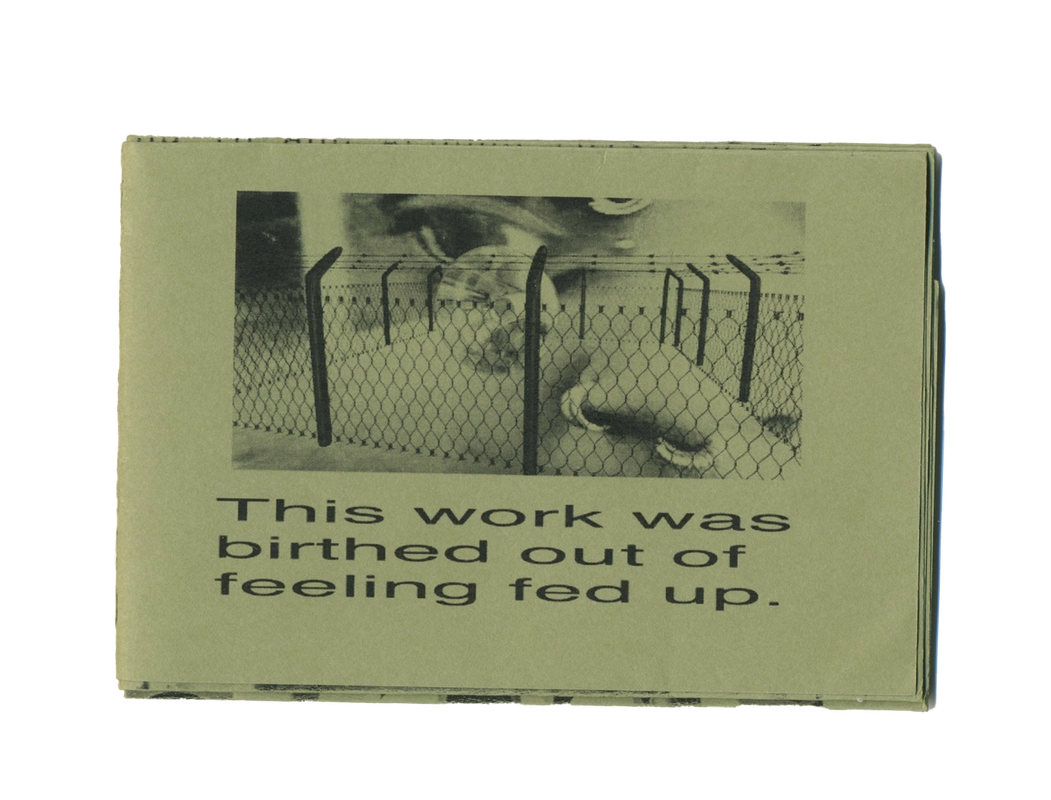 A light green zine with a black and white image of hands behind a fence and the text "This work was birthed out of feeling fed up."